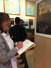 Professor Claudia Valeggia views each of the photographs in the exhibit.